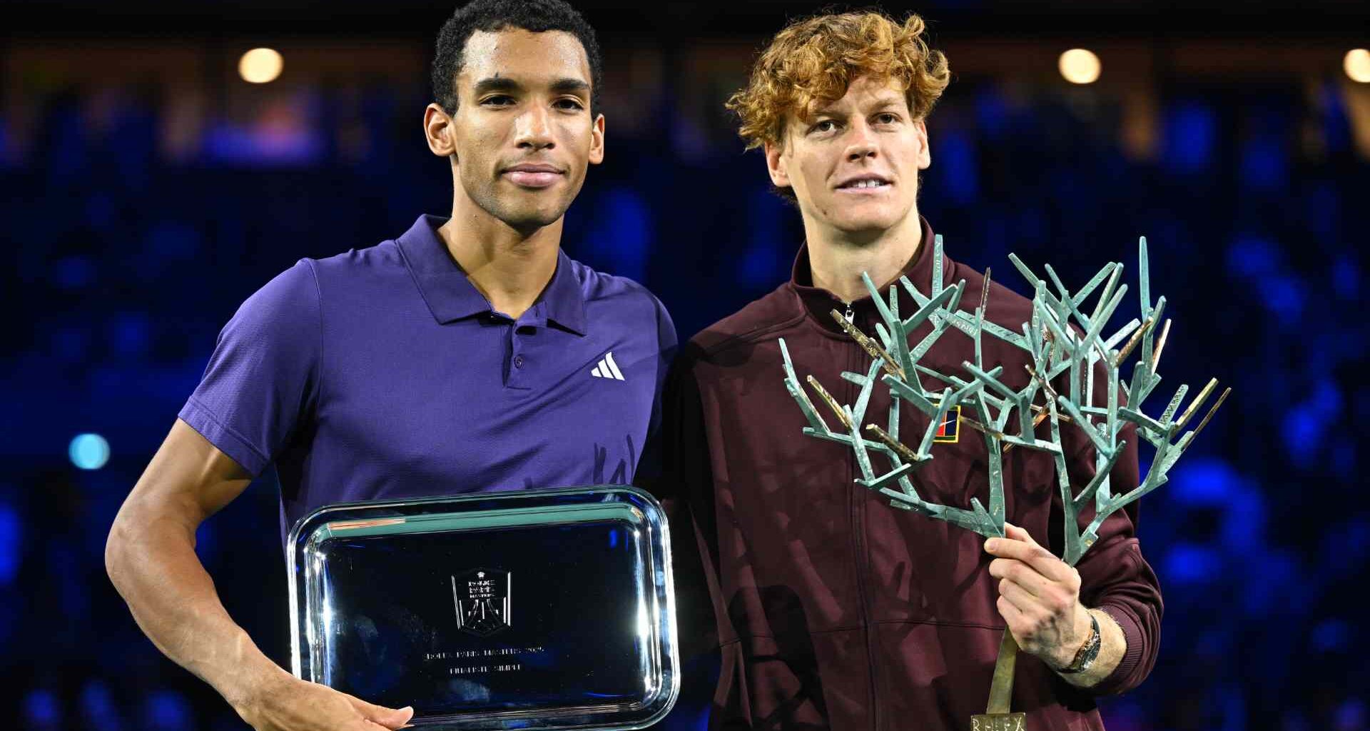 Felix Auger-Aliassime claims his finalist trophy after defeat to Jannik Sinner on Sunday in Paris.