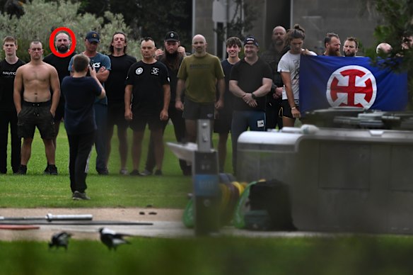 Sitrling Cooper (third from left) and others pose with the neo-Nazi flag created by Thomas Sewell.