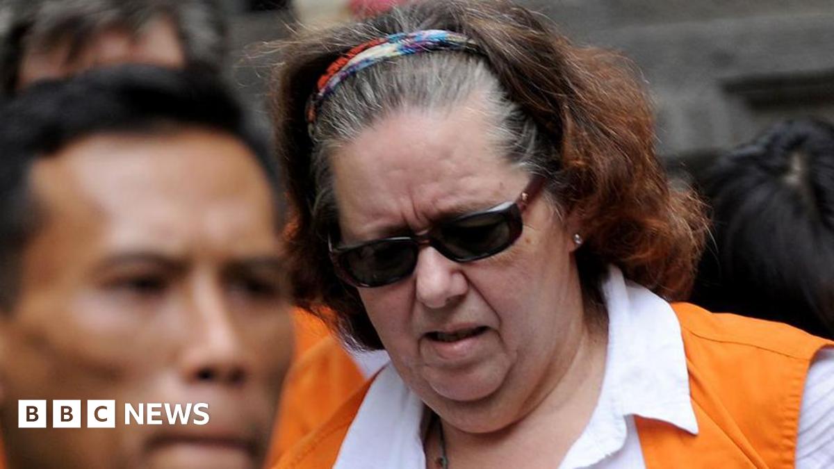 Lindsay Sandiford, in a white shirt and orange vest, arrives at a court in Denpasar on 7 January, 2013