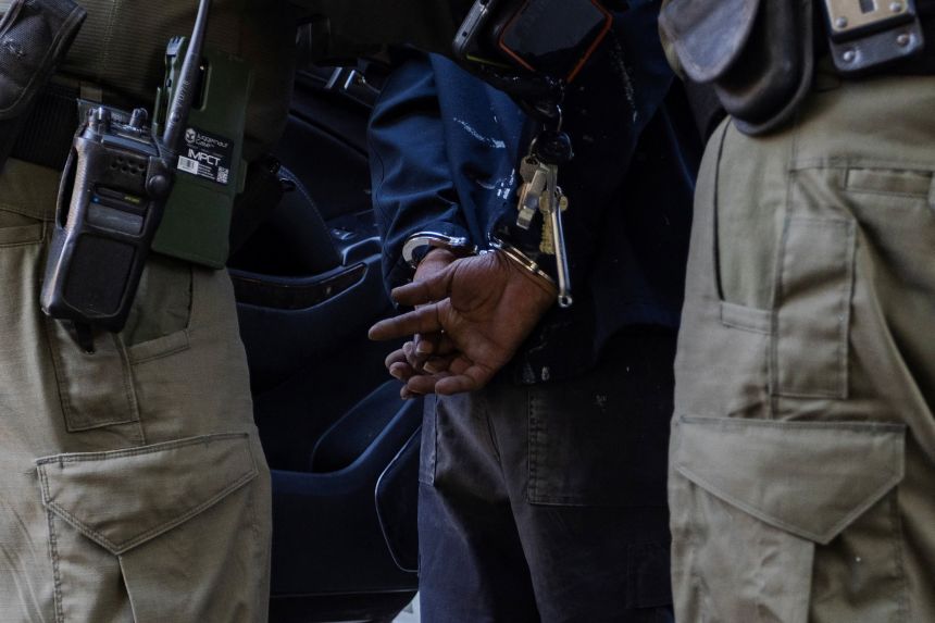 US federal agents detain a man during an immigration raid in Chicago, Illinois, on October 27.