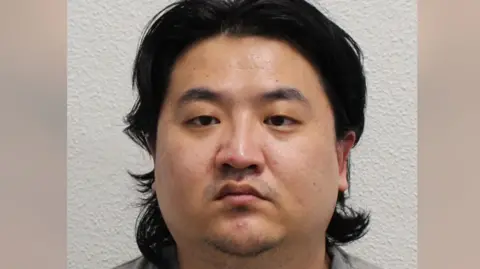 Met Police Man looks at camera in mug-shot