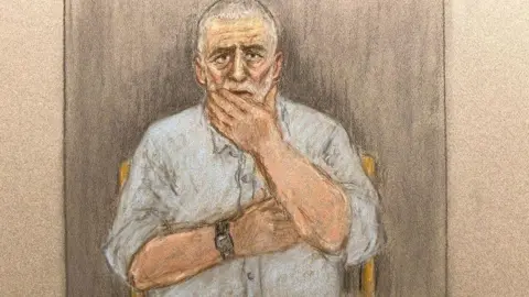 Julia Quenzler/BBC A court sketch showing Peter Sullivan, 68, who has grey and white hair and a blue shirt, holding his hand to his face.