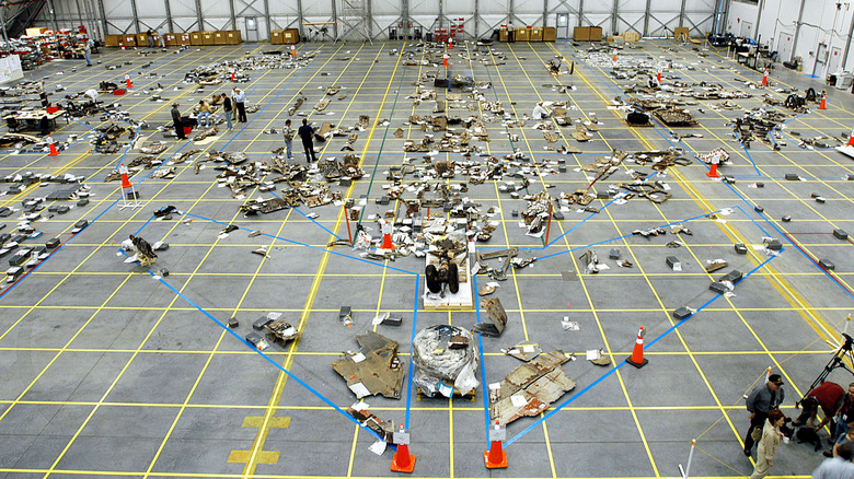 In this NASA handout image debris from the Space Shuttle Columbia is placed on a grid March 27, 2003 at Kennedy Space Center, Florida. NASA is attempting to reassemble debris from the shuttle to learn what caused Columbia to break-up during reentry.