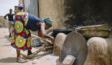 A woman lights her stove to prepare lunch, in the village of Zorro, Burkina Faso.