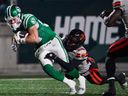 B.C. Lions defensive back Robert Carter Jr.  tackles Saskatchewan Roughriders receiver Joe Robustelli during CFL West Division final in Regina, on Saturday, November 8, 2025.