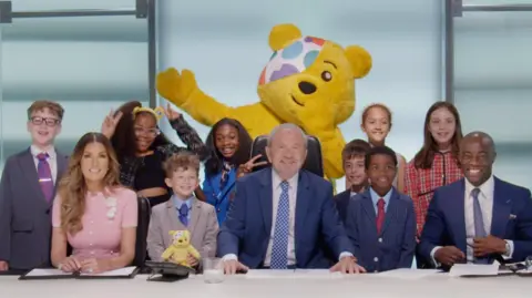 Mini apprentices plus L-R Baroness Karren Brady, Lord Sugar, Pudsey, Tim Campbell