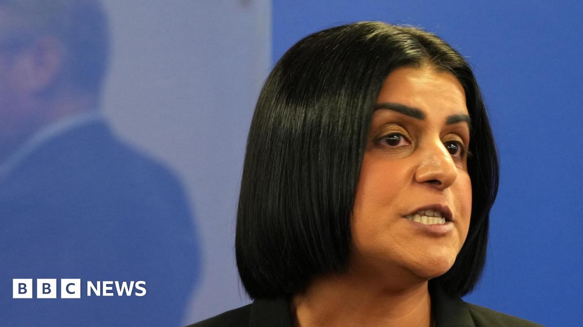 Shabana Mahmood, a woman with dark hair in a bob, speaking against a pale blue background