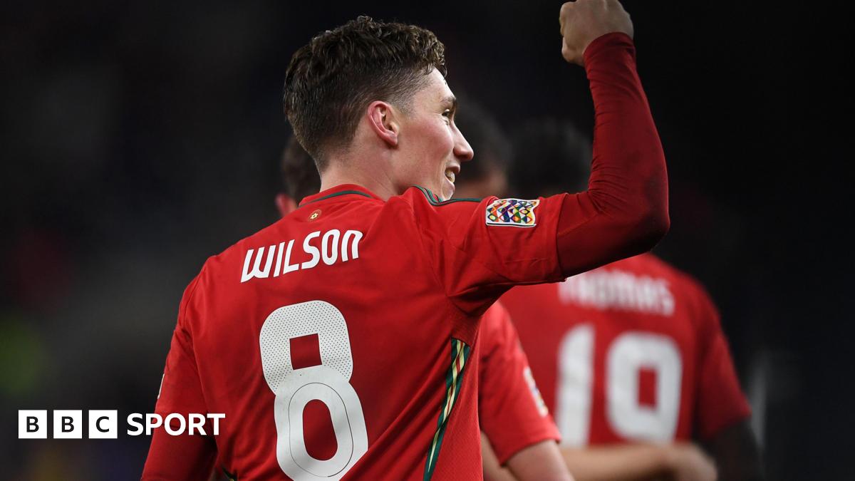 Harry Wilson celebrates scoring for Wales with his back to the camera displaying his name and No.8