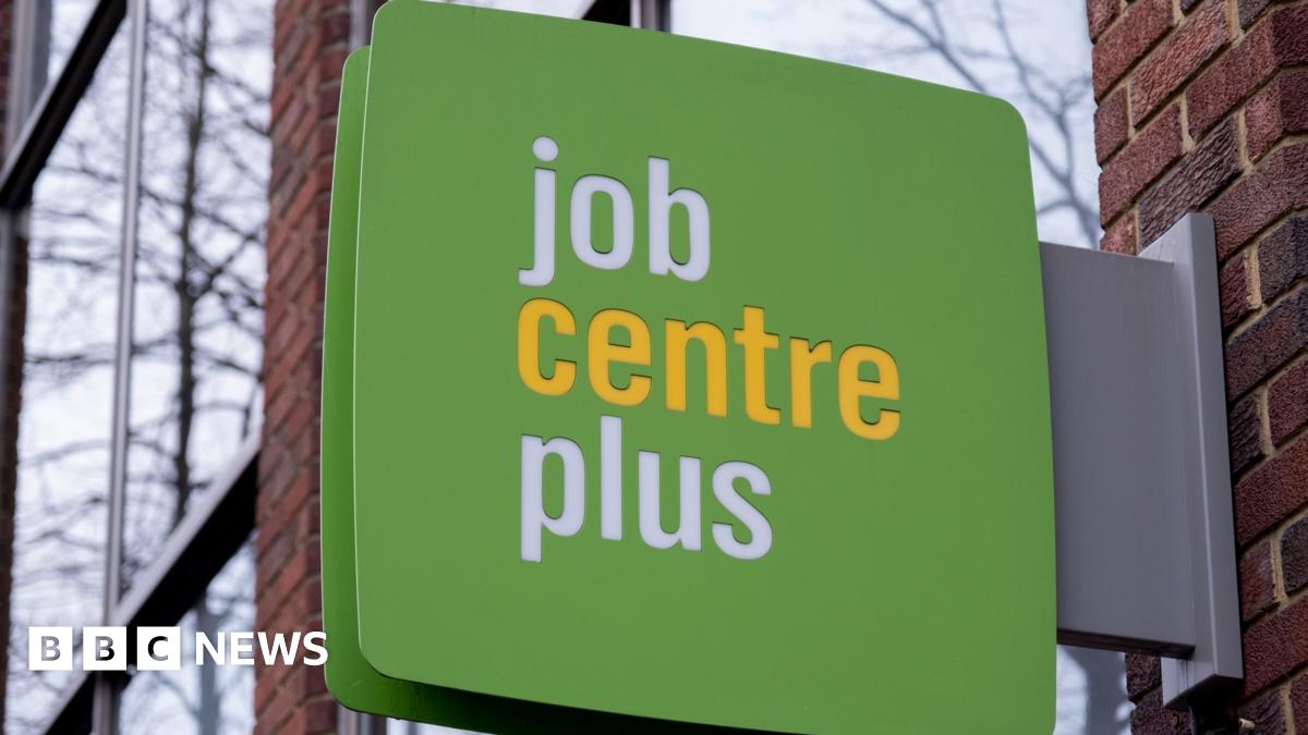 A green sign hangs outside a Job Centre Plus office.