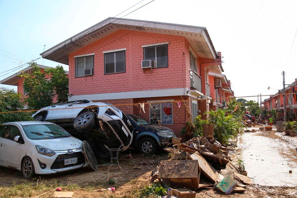 Vehicles are stacked on top of each other due to flooding caused by Typhoon Kalmaegi, in Liloan, Cebu province, central Philippines on Thursday, Nov. 6, 2025. (AP Photo/Jacqueline Hernandez)