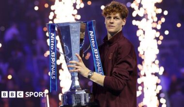Jannik Sinner poses with the ATP Finals trophy