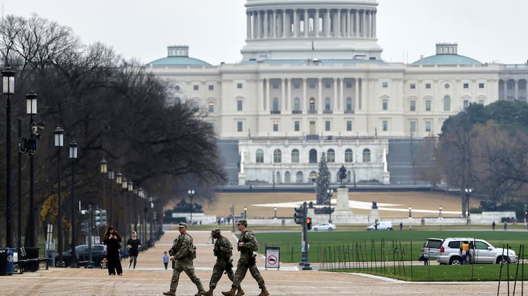 Emergency personnel gather in a cordoned off area where National Guard soldiers were shot near the White House.