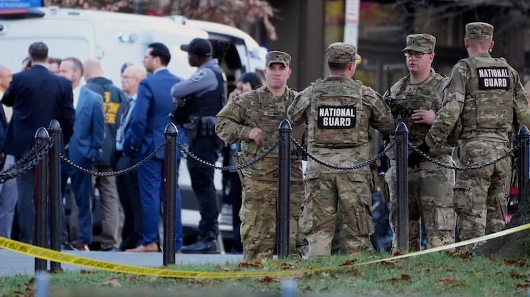 Emergency personnel gather in a cordoned off area where National Guard soldiers were shot near the White House.