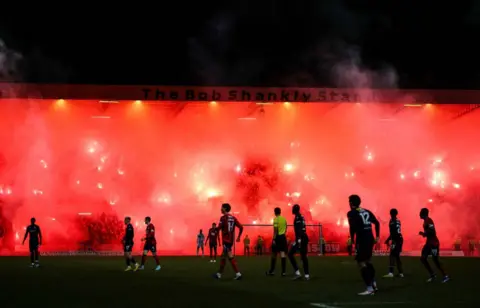 SNS Images Rangers fans light up the Bob Shankly stand with bright red pyro that creates big plumes of smoke