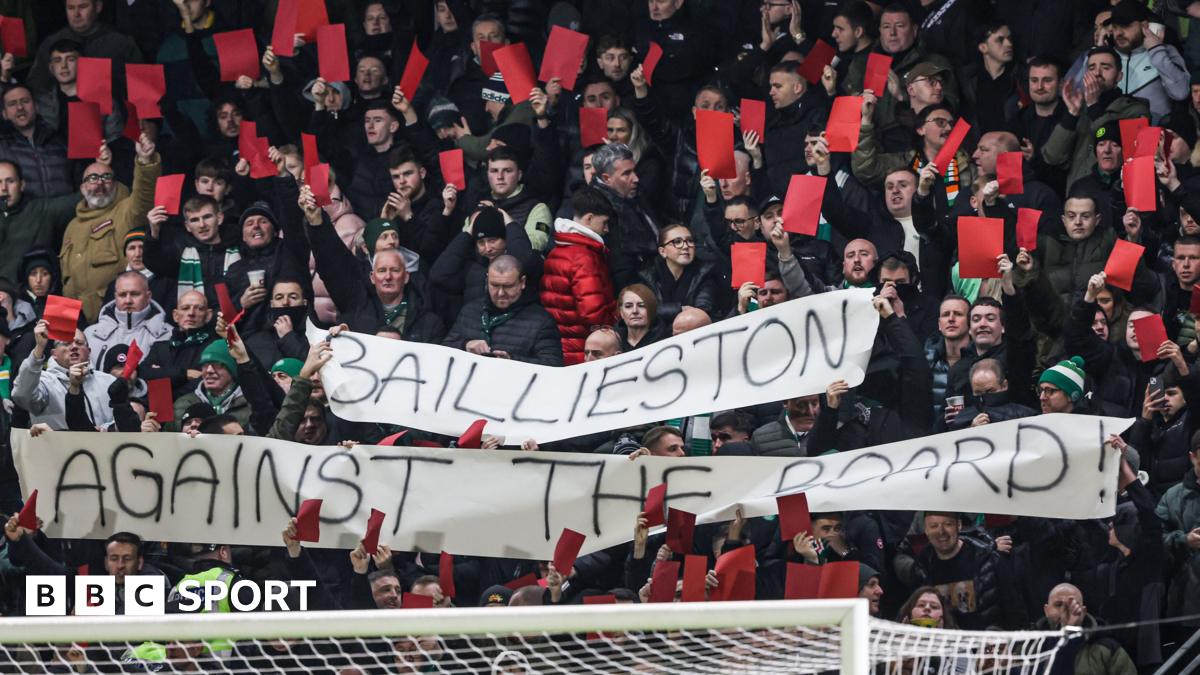 Celtic fans hold up red cards as part of their protest against the board