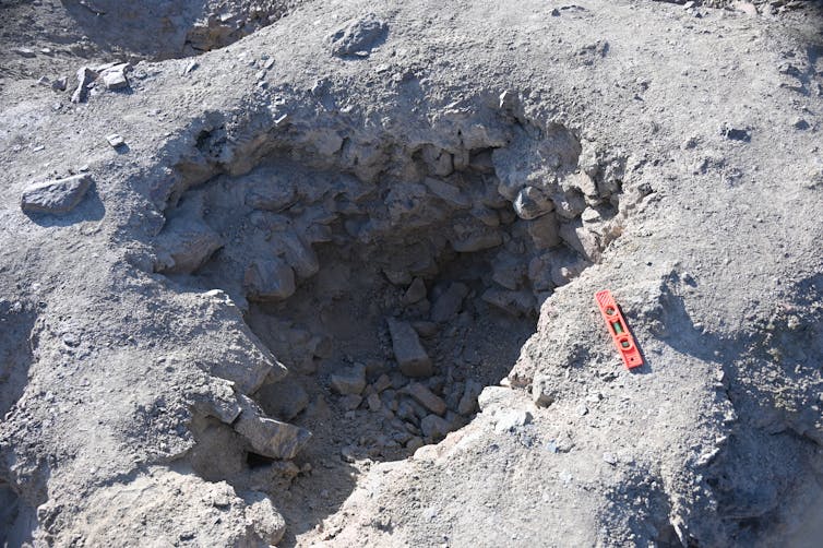 A shallow pit in the ground approximate one metre across