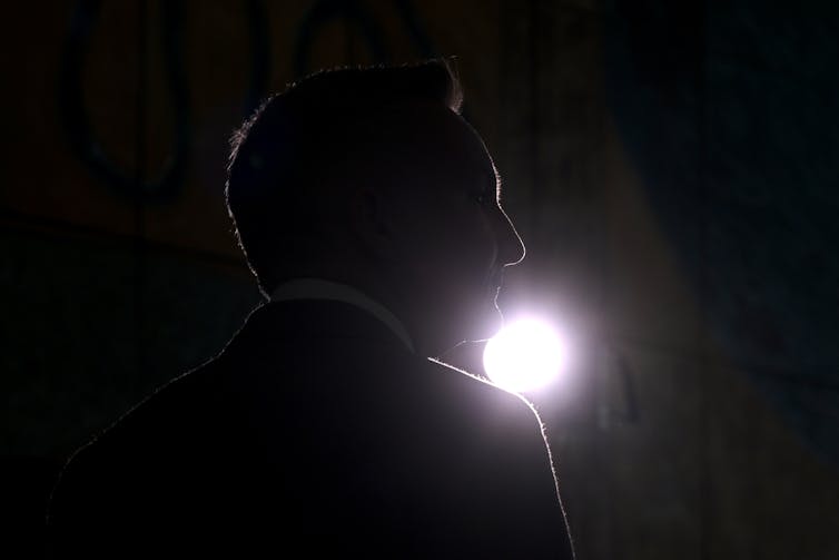 silhouette of man with light behind him.
