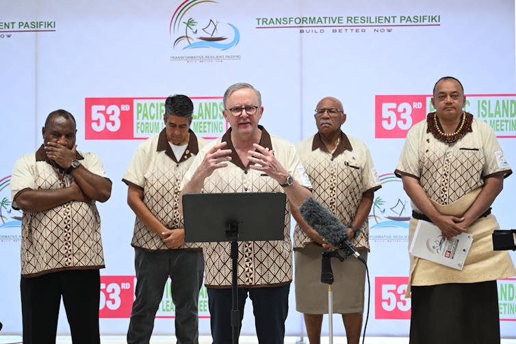 leaders standing at podium.