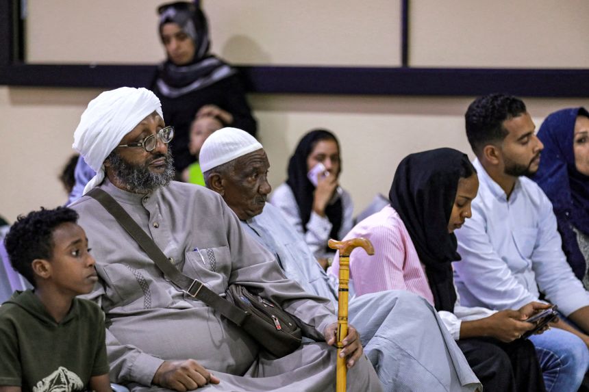 Evacuees from Sudan wait upon arrival at Baghdad International Airport, Iraq, on June 18, 2023.