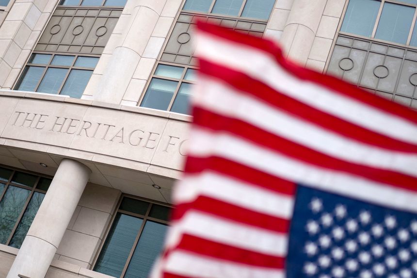 An upside-down American flag is waved outside the Heritage Foundation building in Washington, DC, during an anti-Project 2025 protest on March 16, 2025.