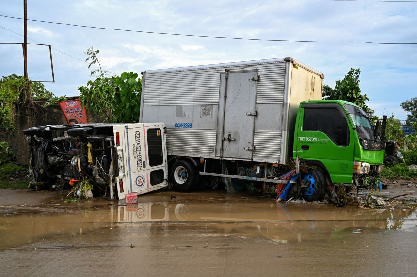 Damaged vehicles are seen along a road in the aftermath of Typhoon Kalmaegi in Mandaue City, Cebu, Philippines, on November 5, 2025.
