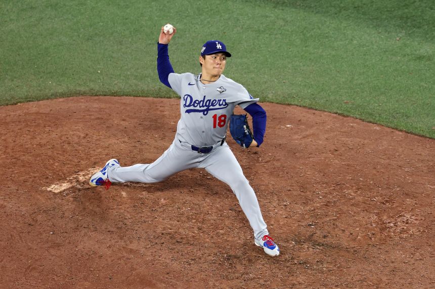 Yoshinobu Yamamoto pitches against the Toronto Blue Jays during the ninth inning in Game 7.