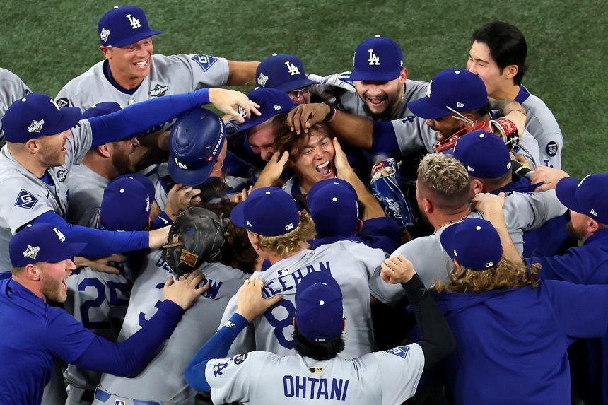 Yoshinobu Yamamoto of the Los Angeles Dodgers celebrates with teammates after defeating the Toronto Blue Jays 5-4 in Game 7.