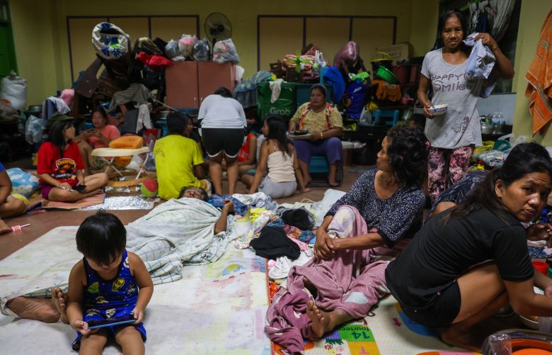 Residents shelter inside a classroom as countless houses have been reduced to rubble or lost electricity in Typhoon Kalmaegi, in Cebu Province, Philippines, on November 5, 2025.