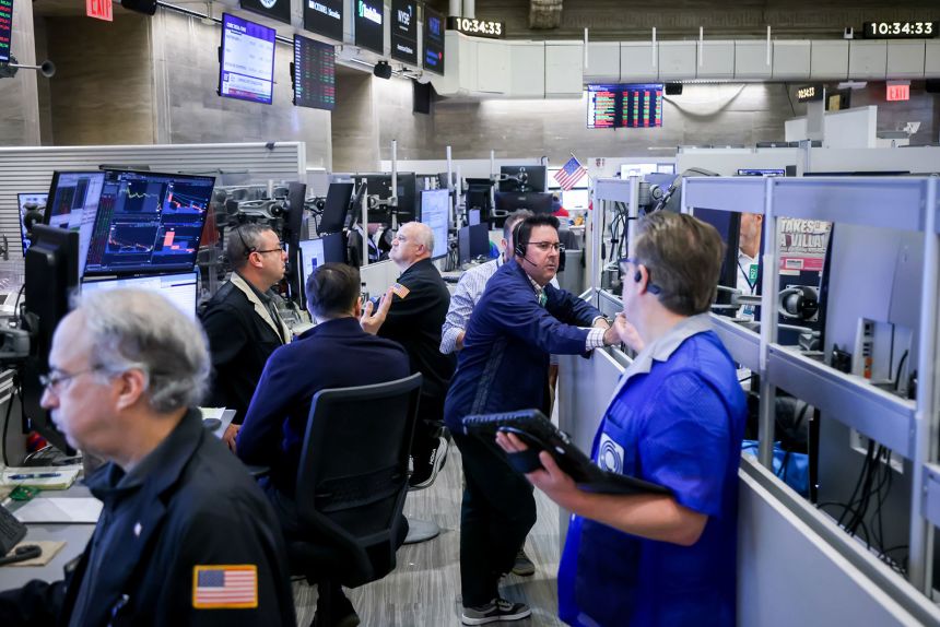 Traders work on the floor of the New York Stock Exchange on November 13.