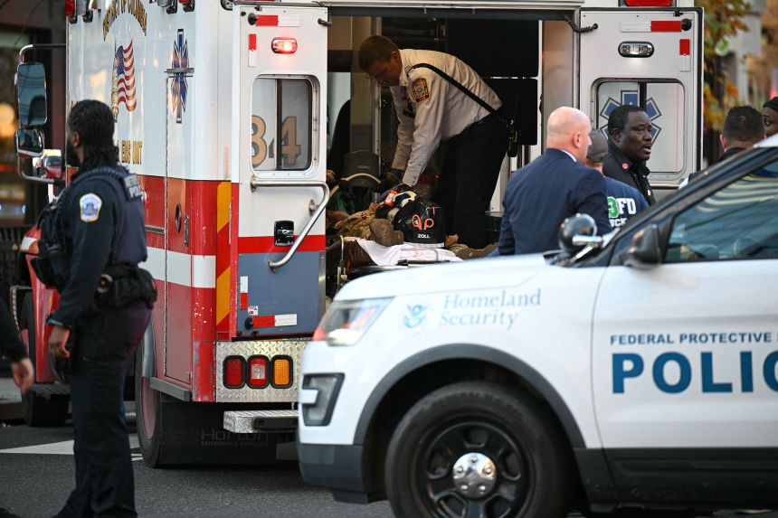 An unidentified man in military fatigues lies on a stretcher inside an ambulance in downtown Washington, DC, on Wednesday.