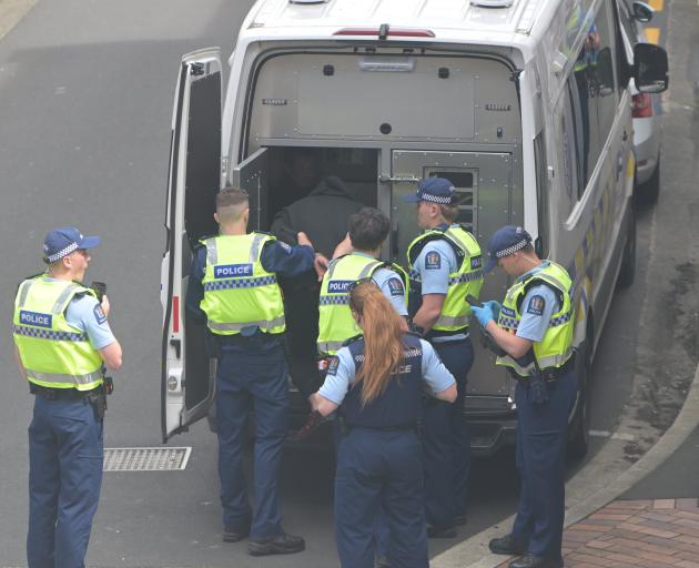 A man put into a police van following an incident at Dunedin's courthouse. PHOTO GERARD O'BRIEN