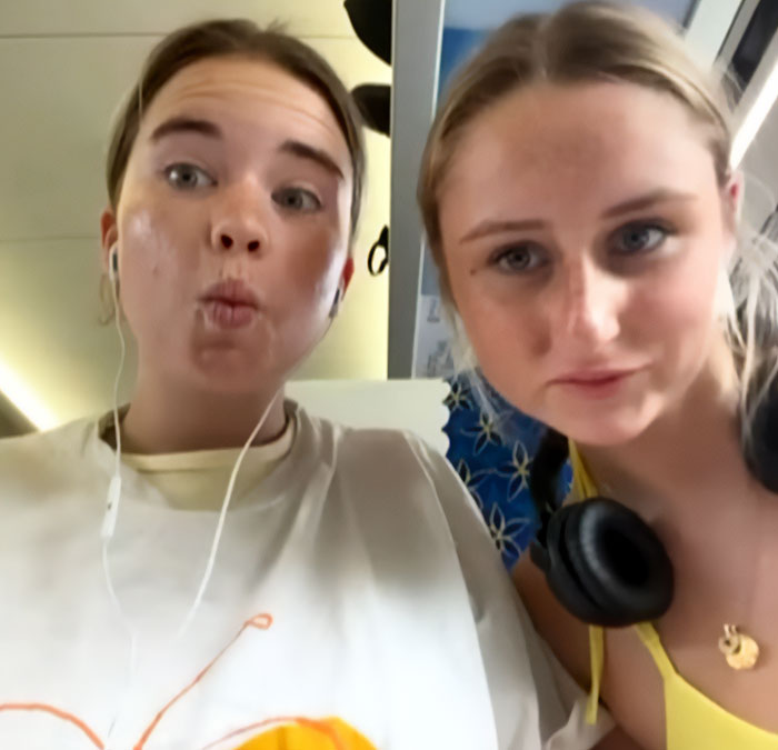 Two young women posing for a selfie, related to parents warning against travel after daughters lose their lives on vacation.