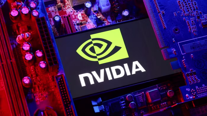 An illustration showing the Nvidia logo on a screen placed among computer motherboard components under red and blue lighting.