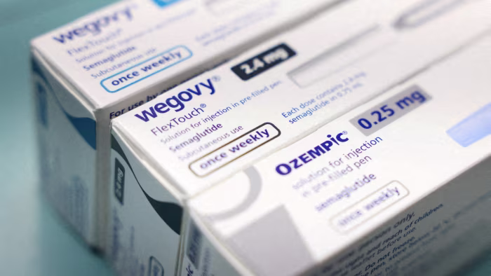 Boxes of Novo Nordisk’s Wegovy and Ozempic medications are displayed on a pharmacy shelf.