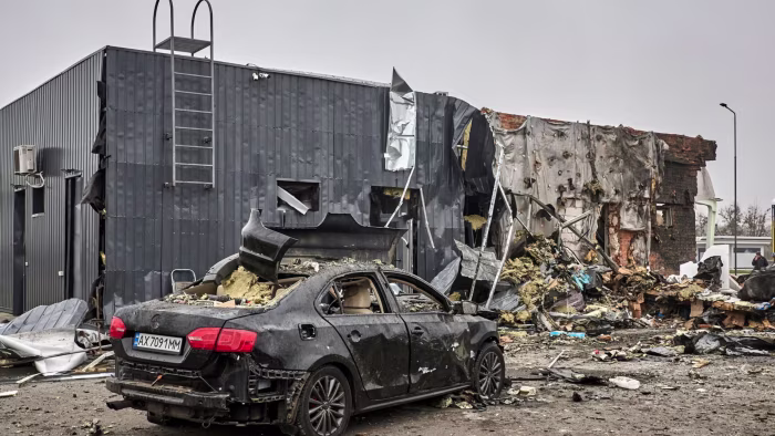 A heavily damaged car sits in front of the destroyed remains of a gas facility after Russian shelling in Kharkiv, Ukraine.