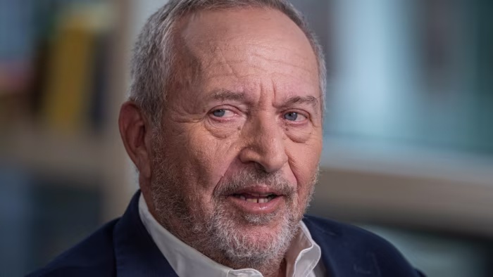 Larry Summers during an interview, looking slightly to the side with a neutral expression.