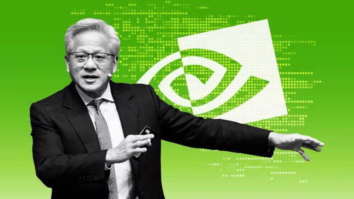 Jensen Huang gestures while speaking, with a large Nvidia logo displayed on a green background behind him.