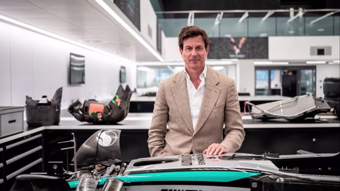 Toto Wolff stands behind a Mercedes-AMG Petronas F1 car part inside the team's workshop