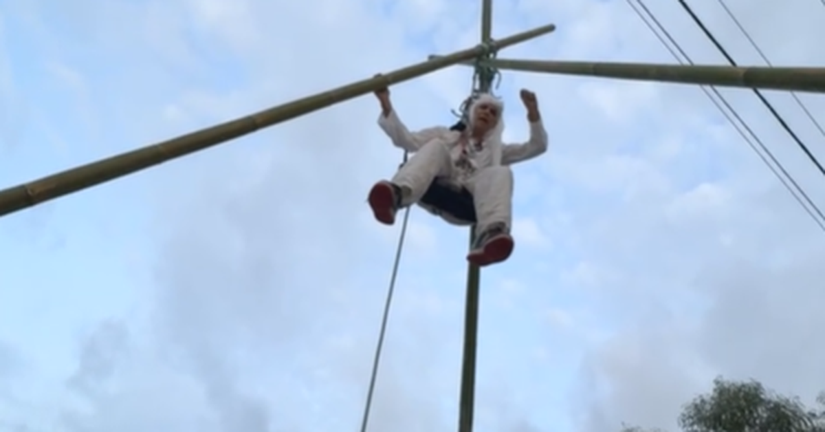 Pro-Palestine activist suspended from giant tripod in Brisbane