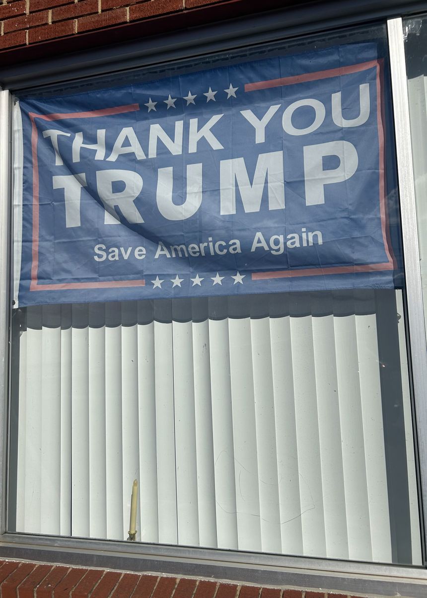 Just feet away from the shuttered clinic, a sign outside of a Churchville storefront reads “Thank you Trump. Save America Again” on November 16, 2025. President Donald Trump carried Augusta County, which includes Churchville, by more than 70 points in 2024.