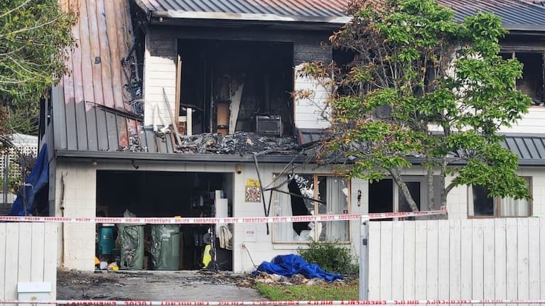 Police guard at the scene of the Bucklands beach double homicide fire.