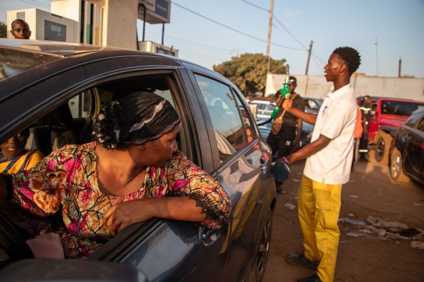 A woman waits to fill her car with fuel at a gas station in Bamako, Mali, on Saturday.