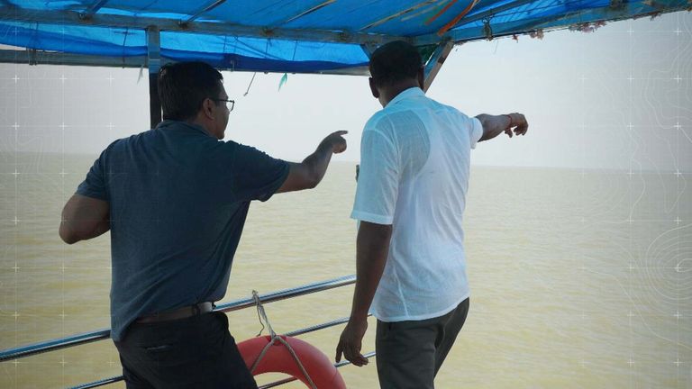 Arun Pramanik (R), with Sky's Neville Lazarus, points to where his home used to be