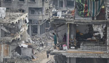 A man and a woman stand in their apartment, damaged by Israeli strikes, in Gaza City. Pic: AP