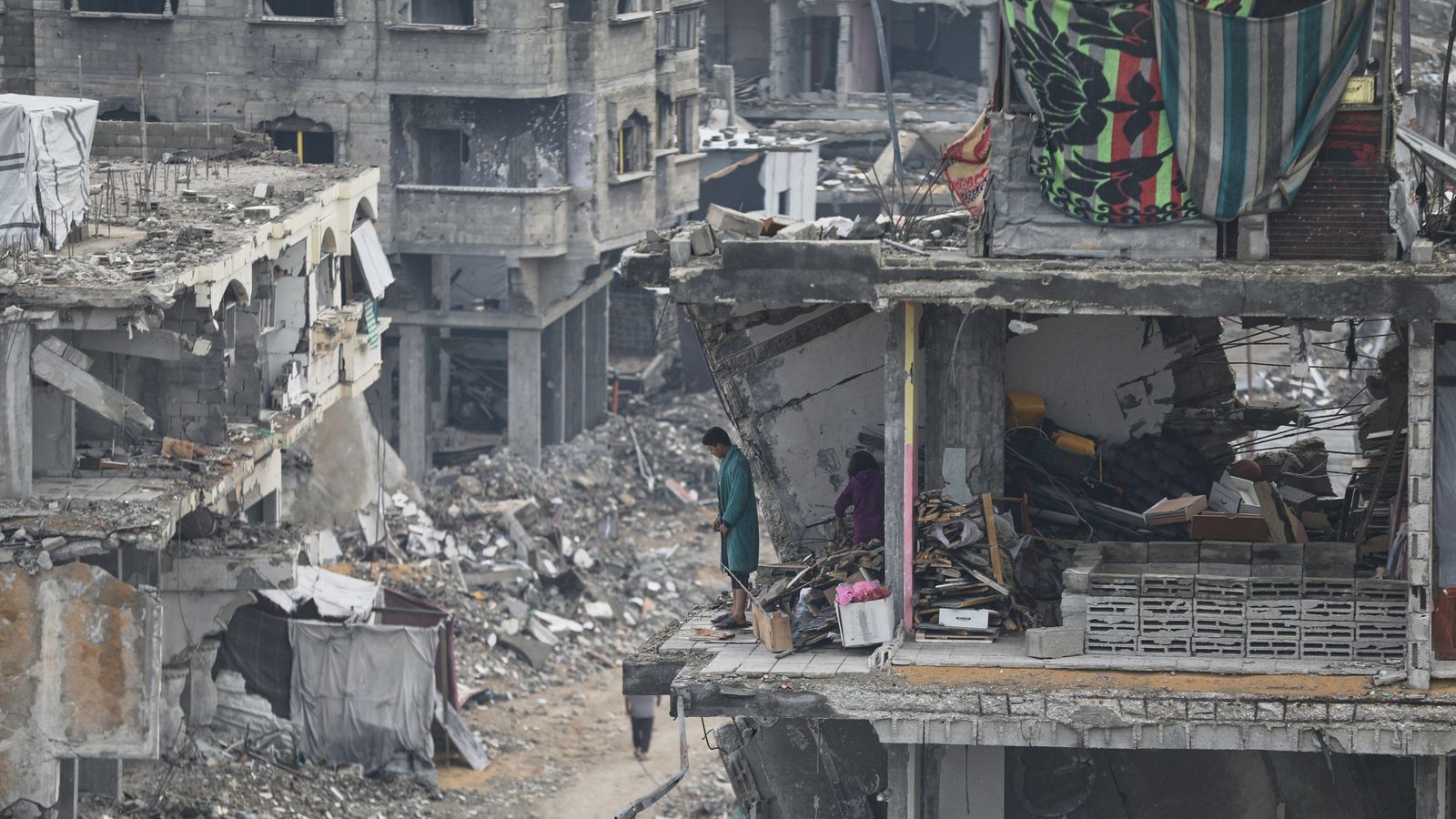 A man and a woman stand in their apartment, damaged by Israeli strikes, in Gaza City. Pic: AP