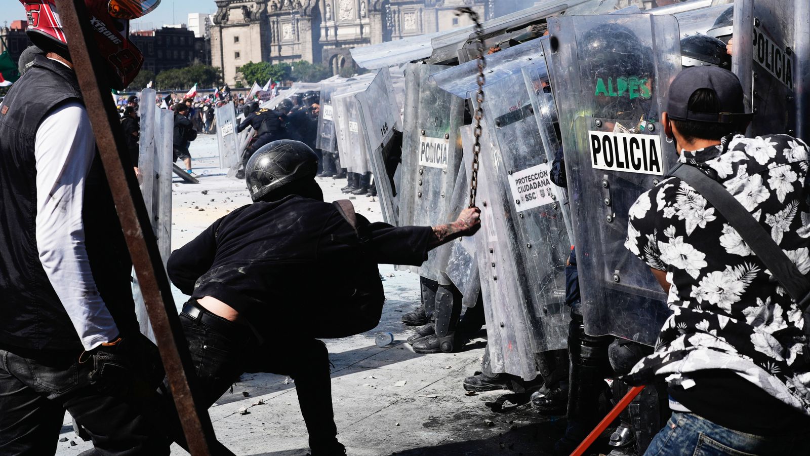 A protester strikes at riot police with a metal chain during a youth anti-government protest in Mexico City. Pic: AP
