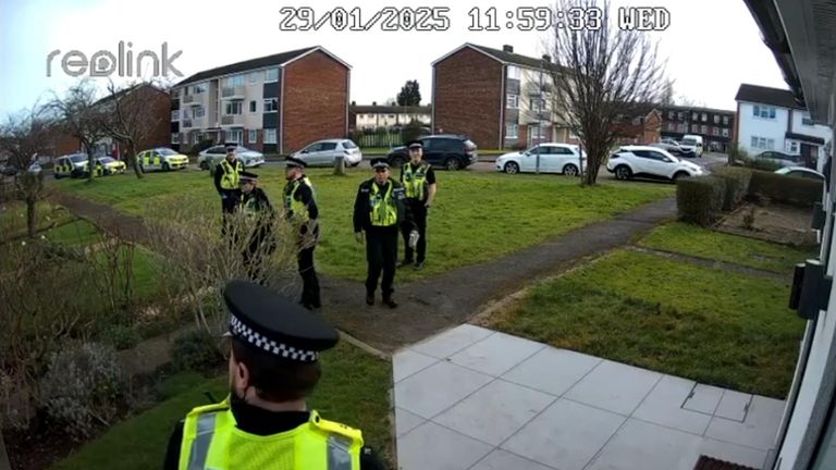 The six police officers outside the couple's house. Pic: Maxie Allen/Times Radio