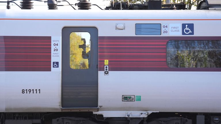 A forensic investigator photographing inside the train at Huntingdon train station in Cambridgeshire. Pic: PA 