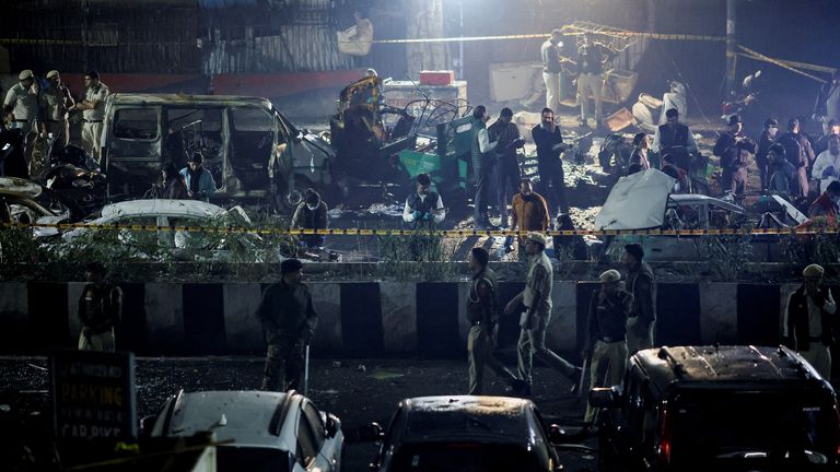Police officers and forensic technicians work at the site of the explosion. Pic: Reuters