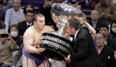 Ukrainian sumo wrestler Danylo Yavhusishyn, 21, receives the Prime Minister's Cup. Pic:  Kyodo/via Reuters